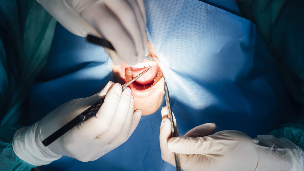 Dentist working in his office with a patient.