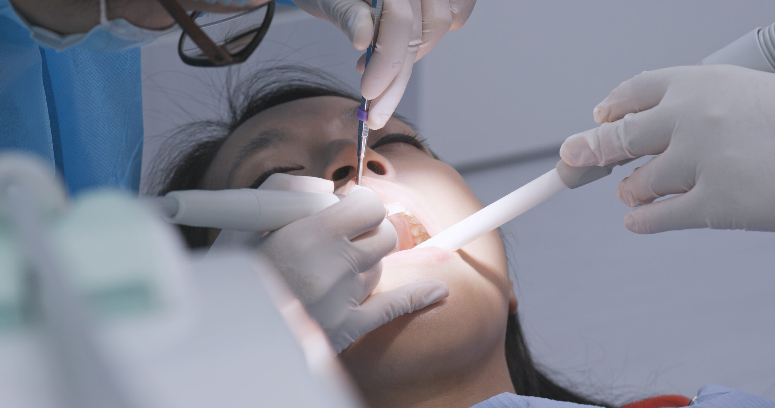 Woman undergo professional tooth whitening and ultrasound cleaning at dental clinic